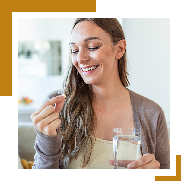 image of a woman taking a pill